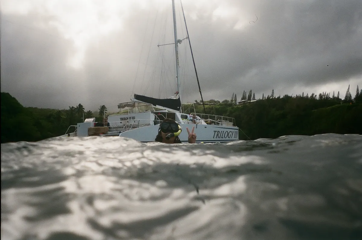 sandy snorkeling in front of the trilogy boat