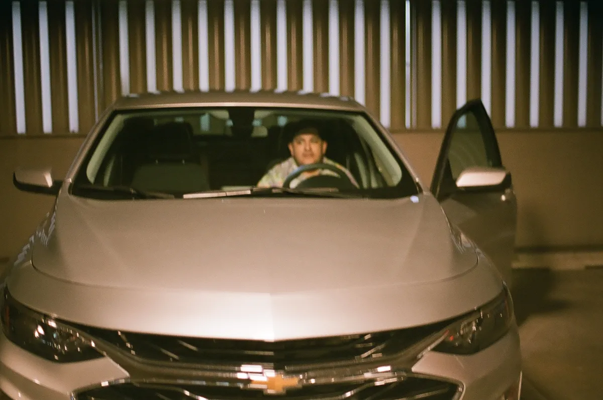 ryan in driver's seat of rental car
